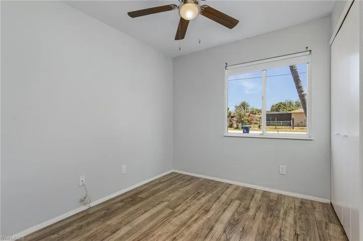 Unfurnished room with ceiling fan and wood-type flooring