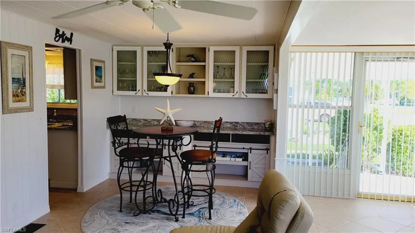 Breakfast area featuring coffee/wine bar and storage cabinets.