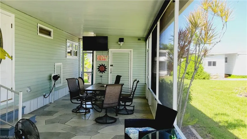 View of enclosed lanai with furniture.