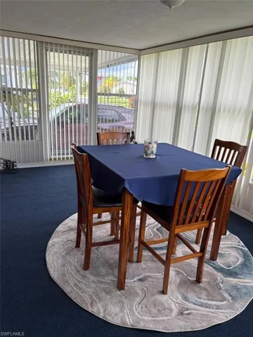 Dining space with dark carpet with a partial view of the water.