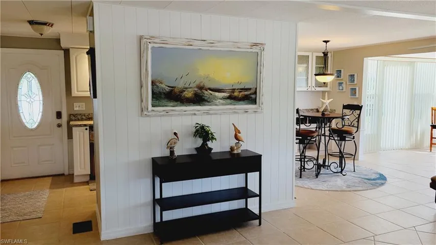 Entryway into kitchen featuring divider wall.