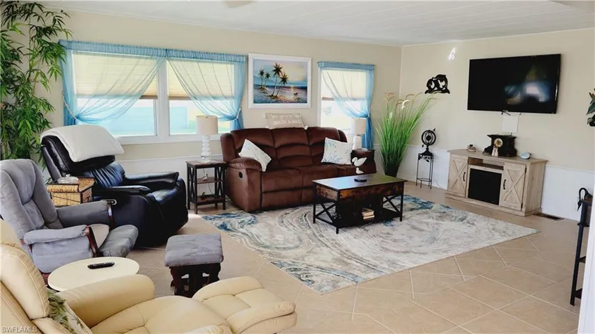 Living area featuring light tile and furnishings.