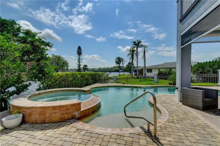 Relaxing pool / spa with a patio and a fenced backyard