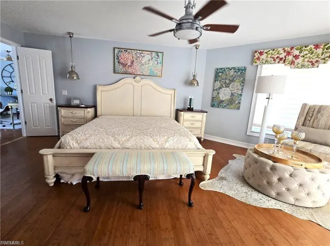 Bedroom featuring dark wood-style floors and ceiling fan