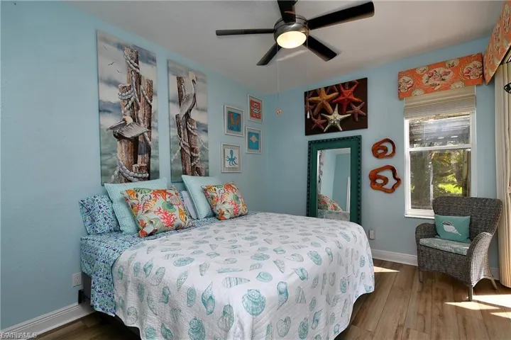Bedroom with dark wood finished floors and a ceiling fan