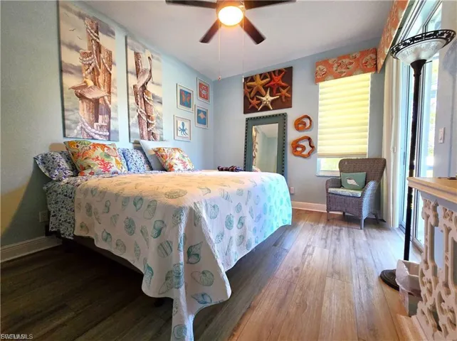 Bedroom featuring dark wood-type flooring and a ceiling fan
