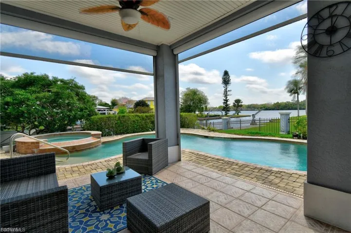 Integrated pool / spa with a patio and a water view