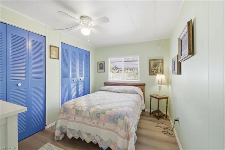 Bedroom #2 with multiple closets, wood finished floors, and a ceiling fan
