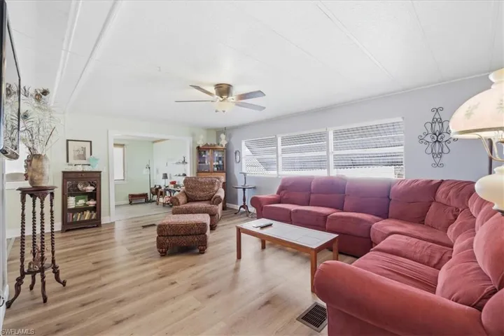 Living room featuring light wood-style floors and ceiling fan