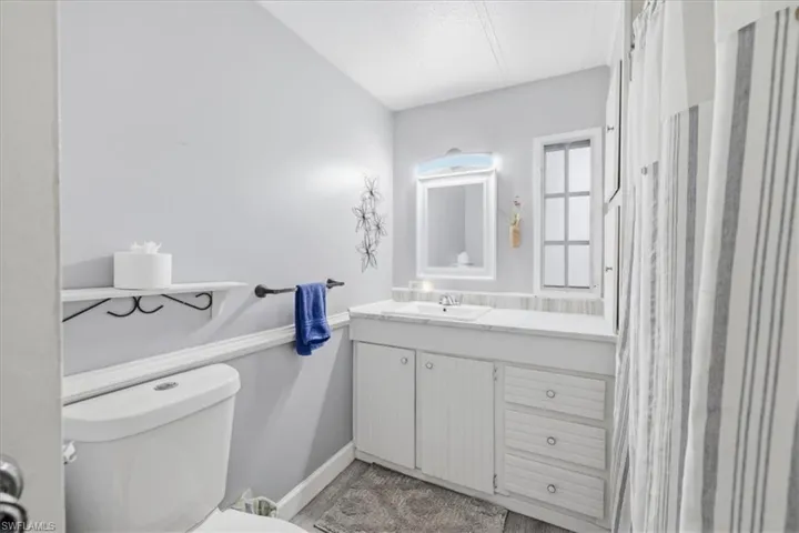 Bathroom #2 featuring vanity and a shower with curtain