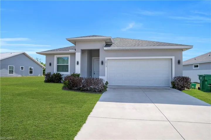 Contemporary single-story residence with a gray stucco exterior and a dark gray shingle roof