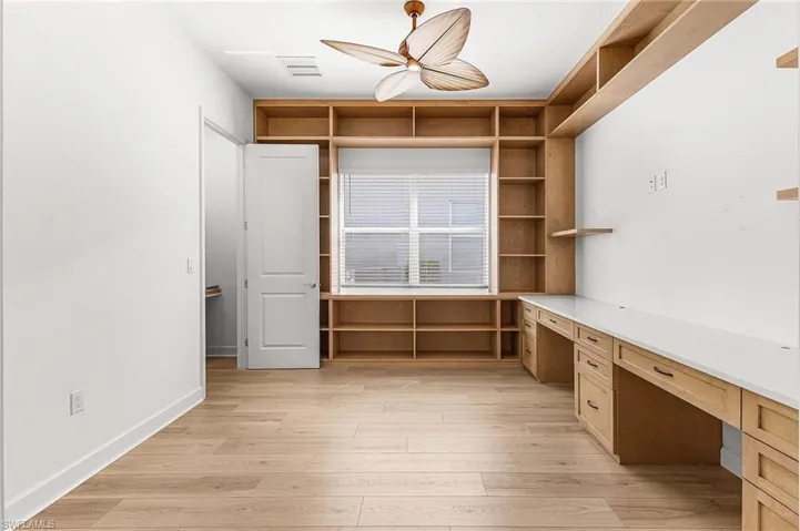 Den with custom desks and shelving