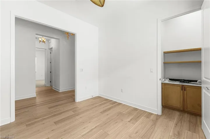 Den has closet with custom cabinet