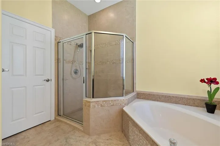 Bathroom with tile floors and shower with separate bathtub.