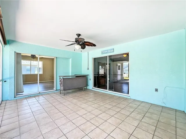 Spare room featuring ceiling fan and light tile floors