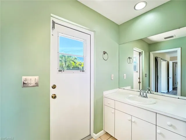 Bathroom featuring tile flooring and vanity
