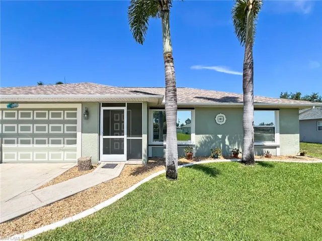 Ranch-style house with a front lawn and a garage