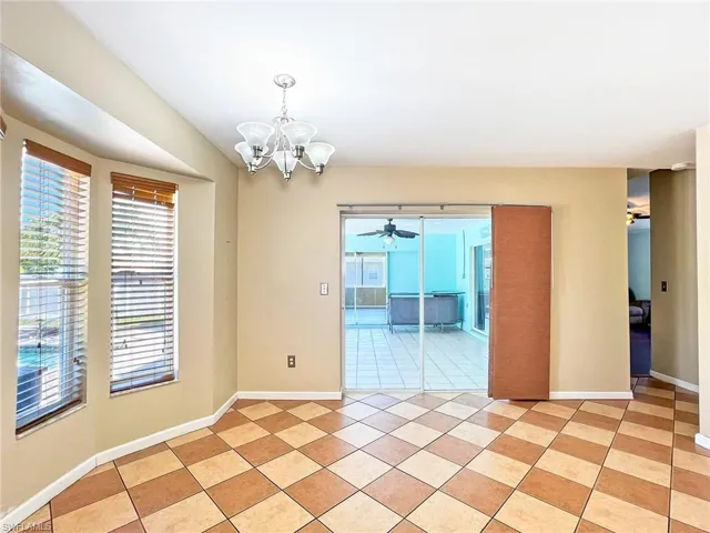 Empty room featuring a healthy amount of sunlight and light tile floors