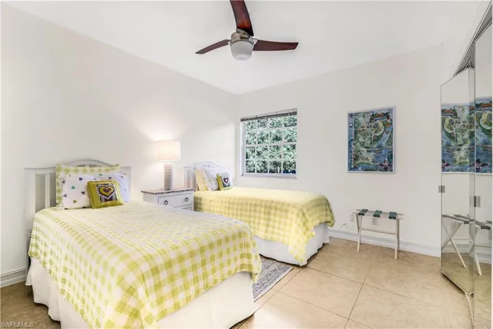 Tiled bedroom with ceiling fan