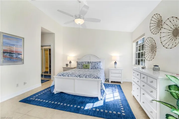 Bedroom featuring ceiling fan and light tile floors