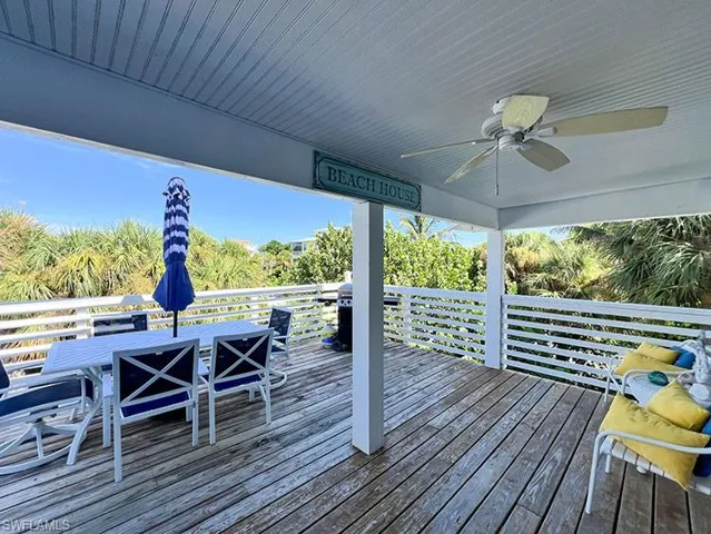 Wooden deck featuring ceiling fan