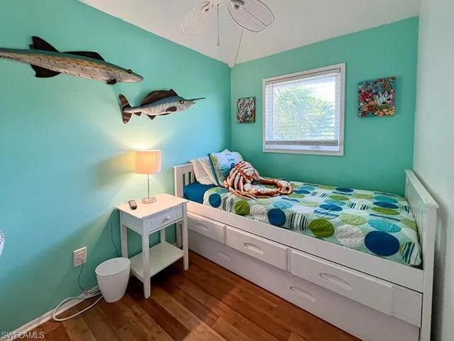 Bedroom featuring wood-type flooring and ceiling fan
