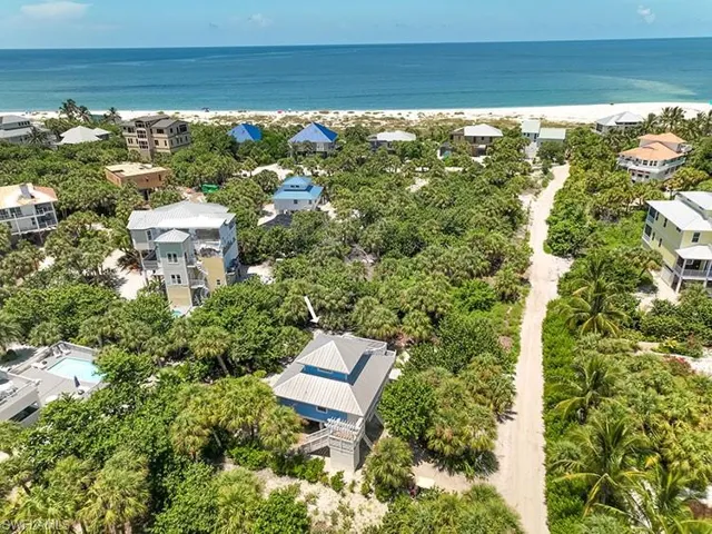 Birds eye view of property with a water view