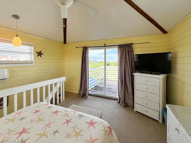Carpeted bedroom with lofted ceiling with beams, access to outside, and ceiling fan