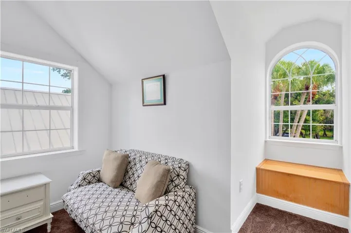dormer windows in bedroom with storage bin