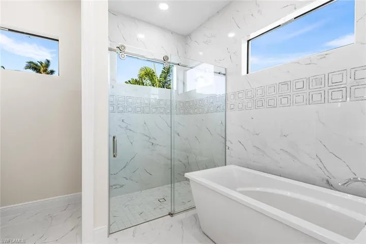 Large soaking tub with tiled walls