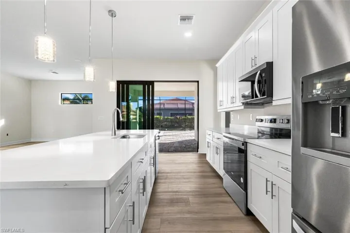 Kitchen flows out to backyard pool area. Great for entertaining.