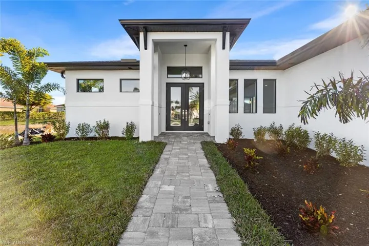 Grand entry with transom window and French doors