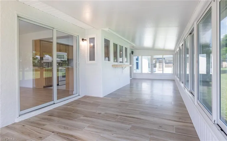 Unfurnished sunroom with wood finished floors