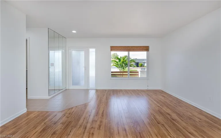 Spare room with wood finished floors and baseboards