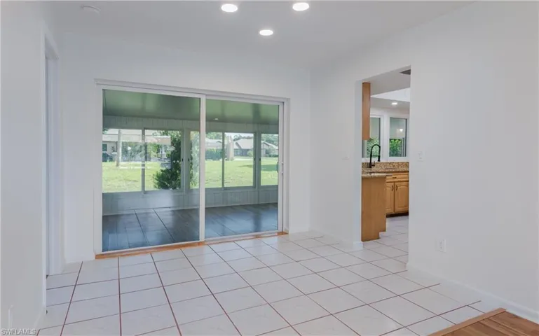 Empty room with recessed lighting and light tile patterned flooring
