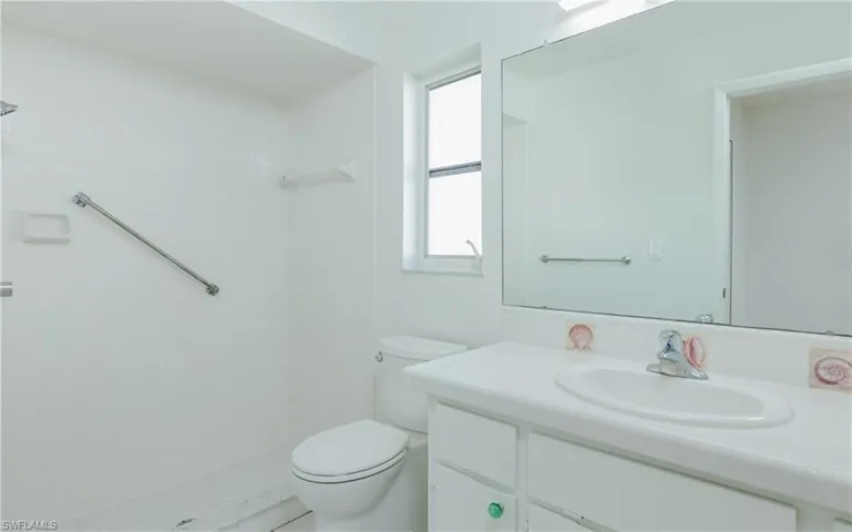 Bathroom featuring vanity and a tile shower