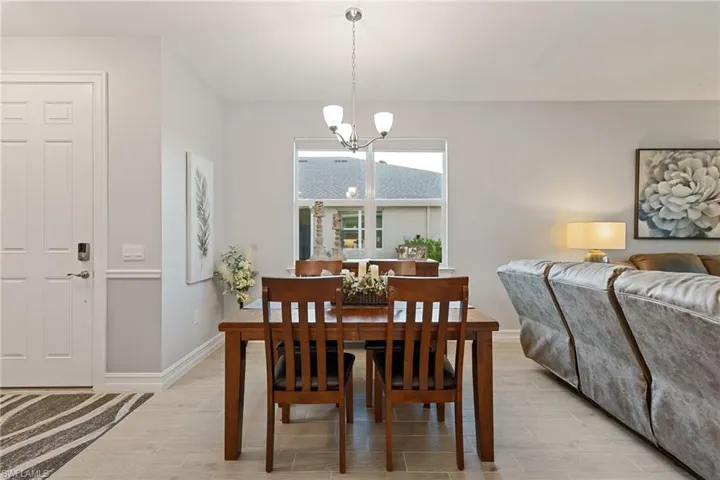 Dining area featuring wood finish floors and a chandelier