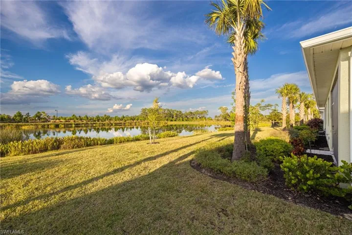View of grassy yard with a water view