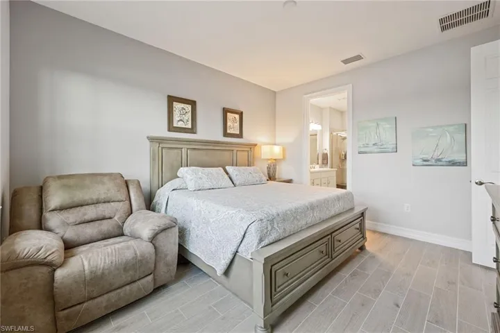 Primary Bedroom featuring wood tiled floors and ensuite bath