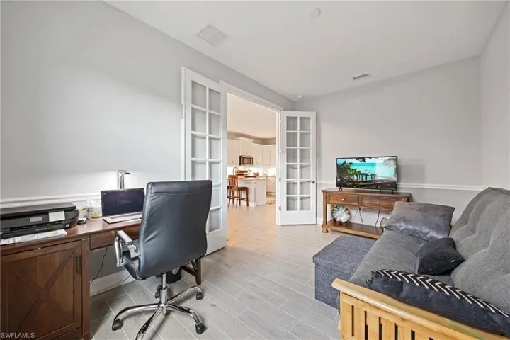 Home Office/den area featuring french doors and wood tiled floors