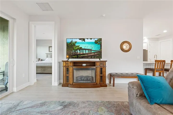 Living room with wood tiled floors and a fireplace