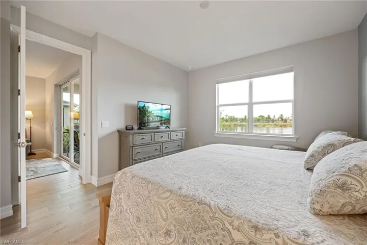 Primary Bedroom featuring wood tiled floors and multiple windows