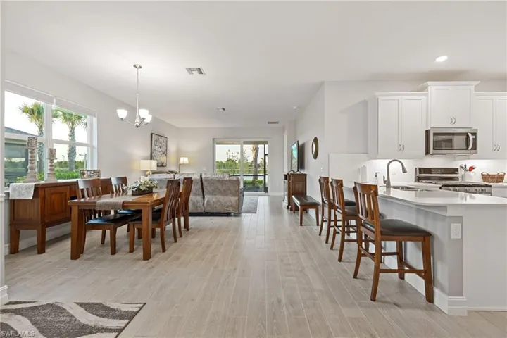 Dining area featuring a chandelier, wood tiled floors, and recessed lighting