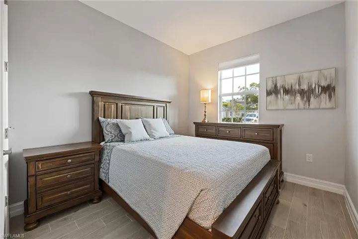Guest Bedroom with baseboards and wood tiled floors