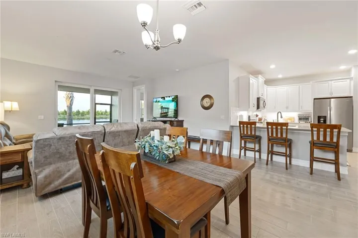 Dining space with wood finish floors and a chandelier