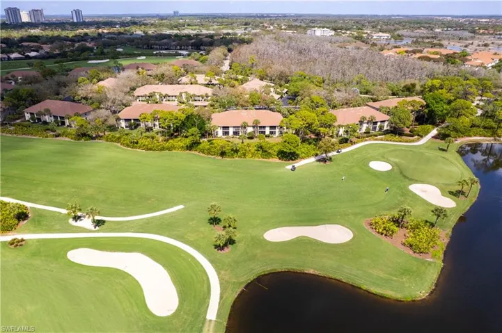 Aerial view of residential area with a golf club and a large body of water