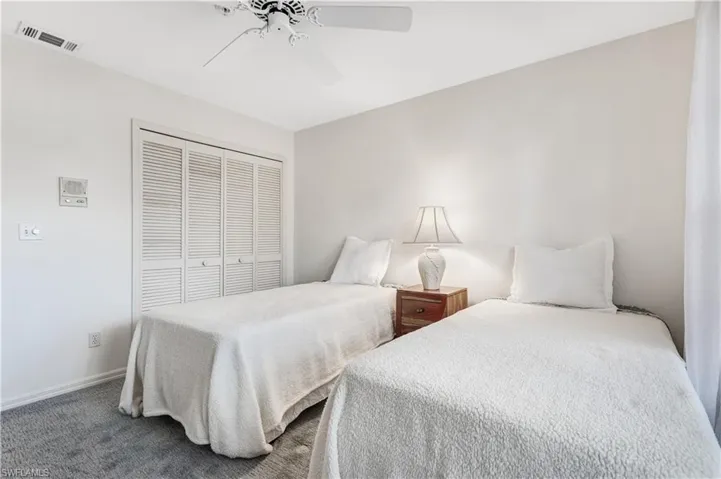 Bedroom featuring a closet, carpet floors, and ceiling fan