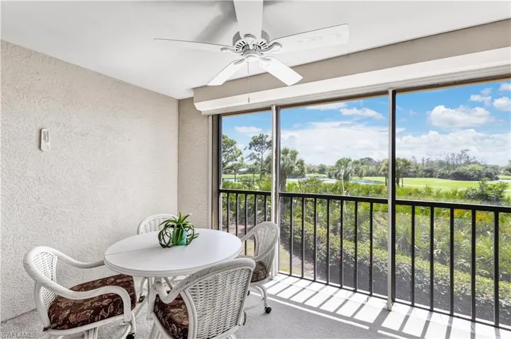Sunroom / solarium featuring ceiling fan, a balcony, and golf course view