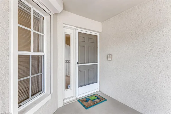 Property entrance with stucco siding