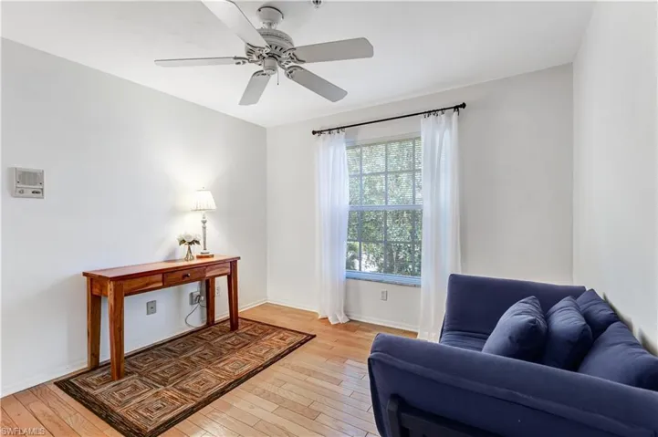 Sitting room featuring light wood-type flooring and a ceiling fan